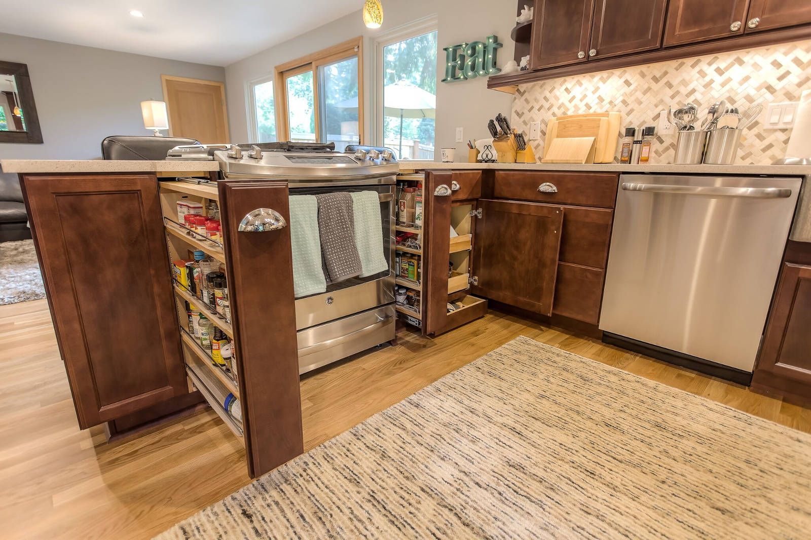 A kitchen with stainless steel appliances and wooden cabinets.