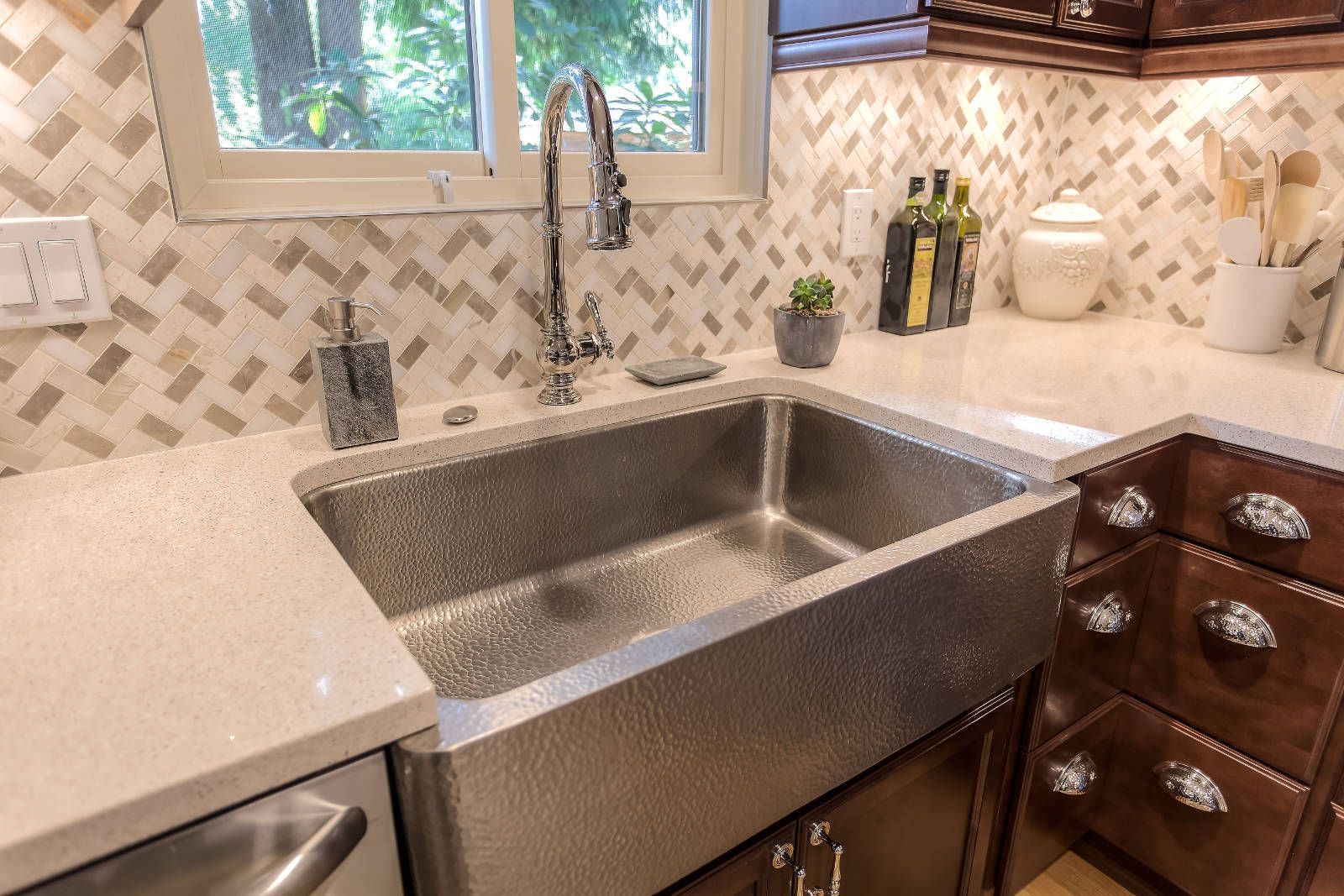 A kitchen with a stainless steel sink and a window