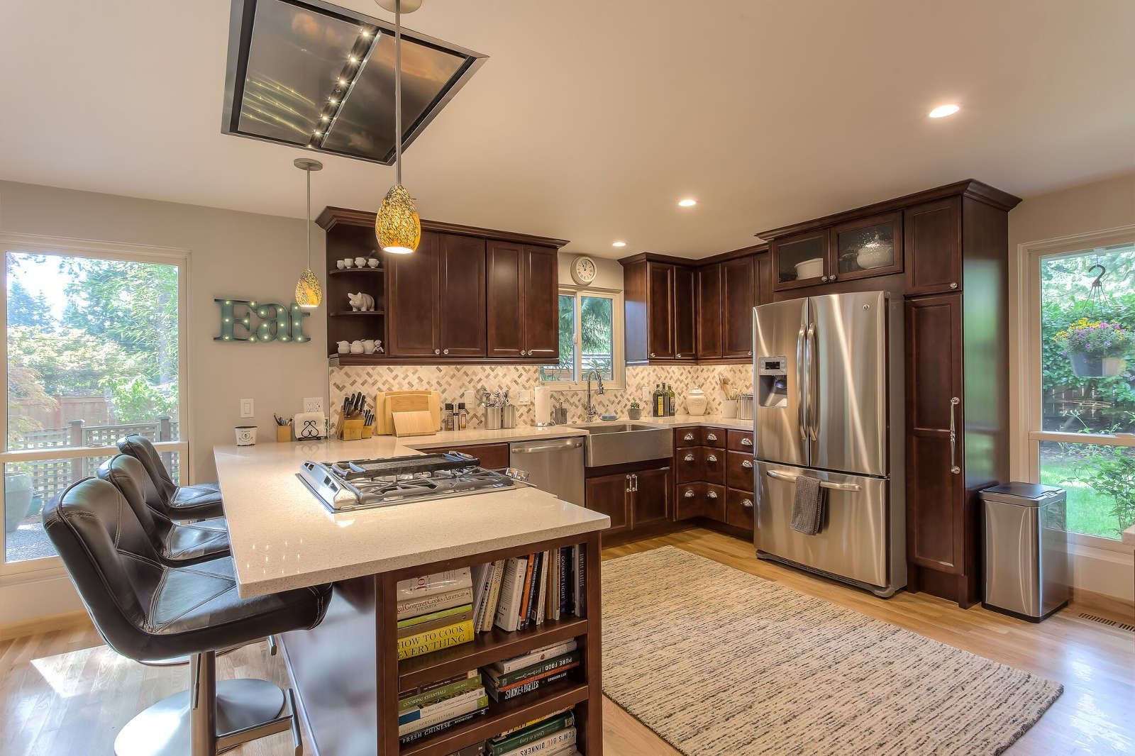 A kitchen with stainless steel appliances and wooden cabinets.