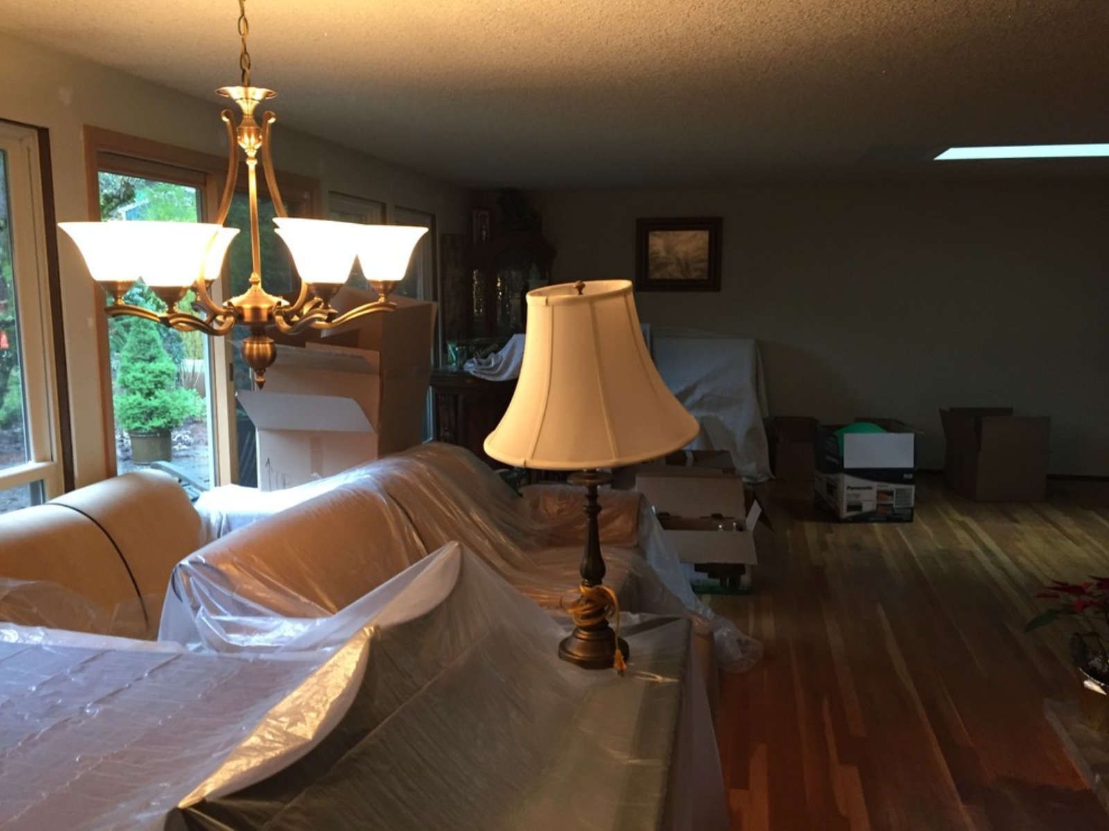 A living room with a lamp and a chandelier