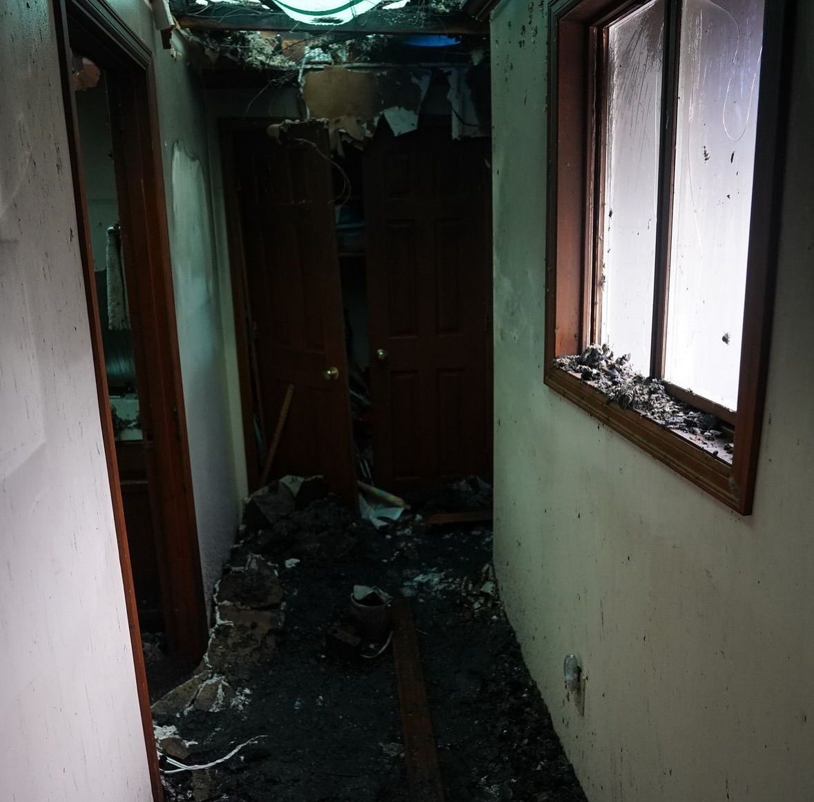A hallway with a window and a door