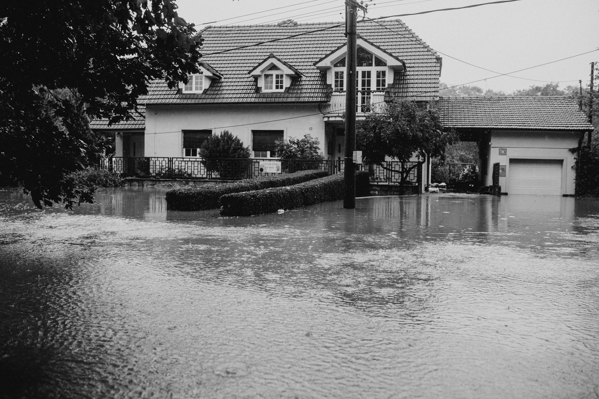 A black and white photo of a flooded house