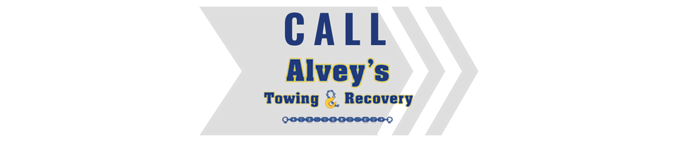 Blue and gray logo reading “CALL Alye’s Towing & Recovery” with stylized chevrons