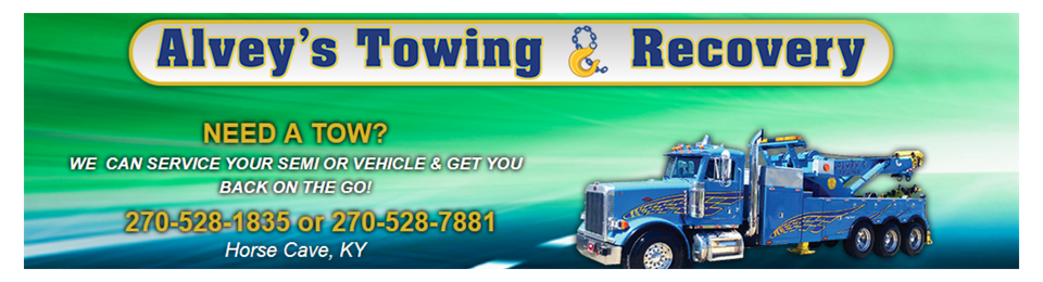 Alvey’s Towing & Recovery banner with tow truck, green sky background, and roadside service contact info