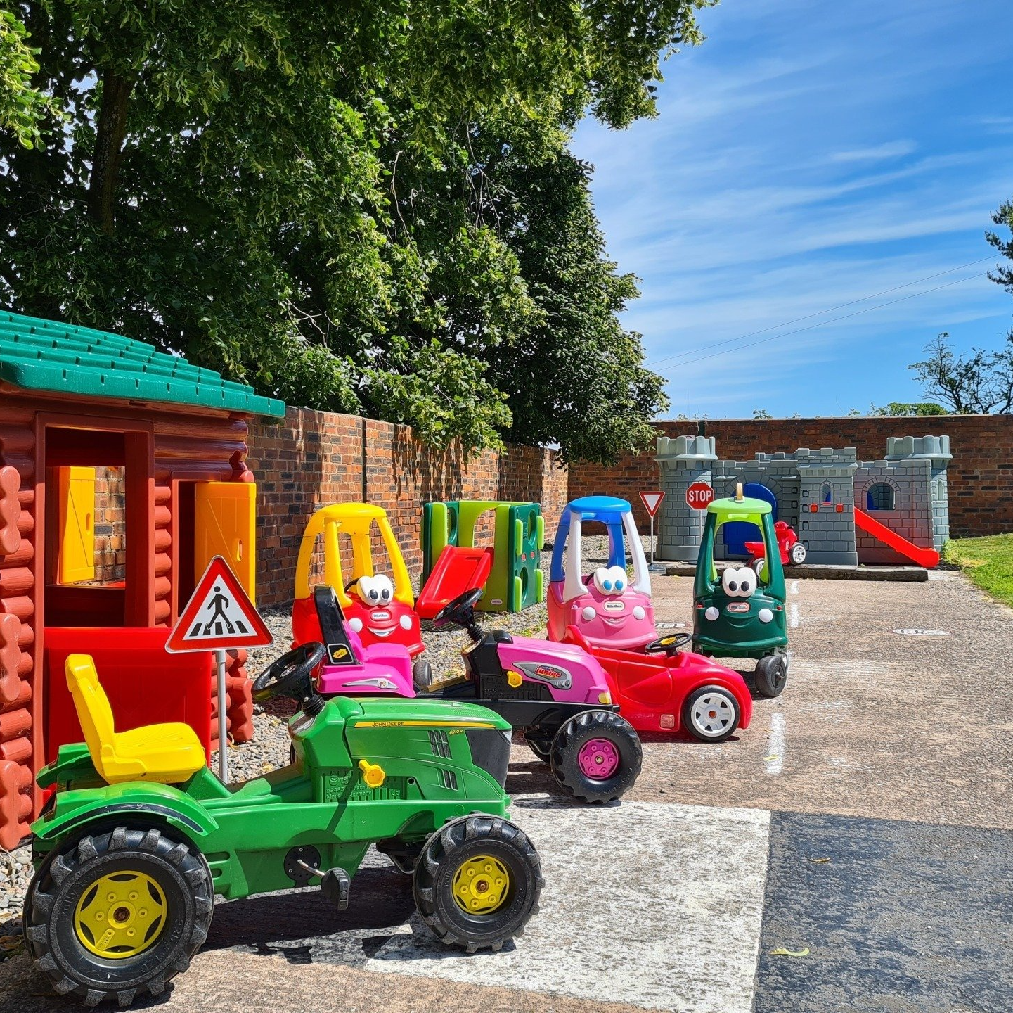 Under 5's Play Area at Alkington Grange Barns Play area with Wendy house, Bubble Cars, ride on Tractors