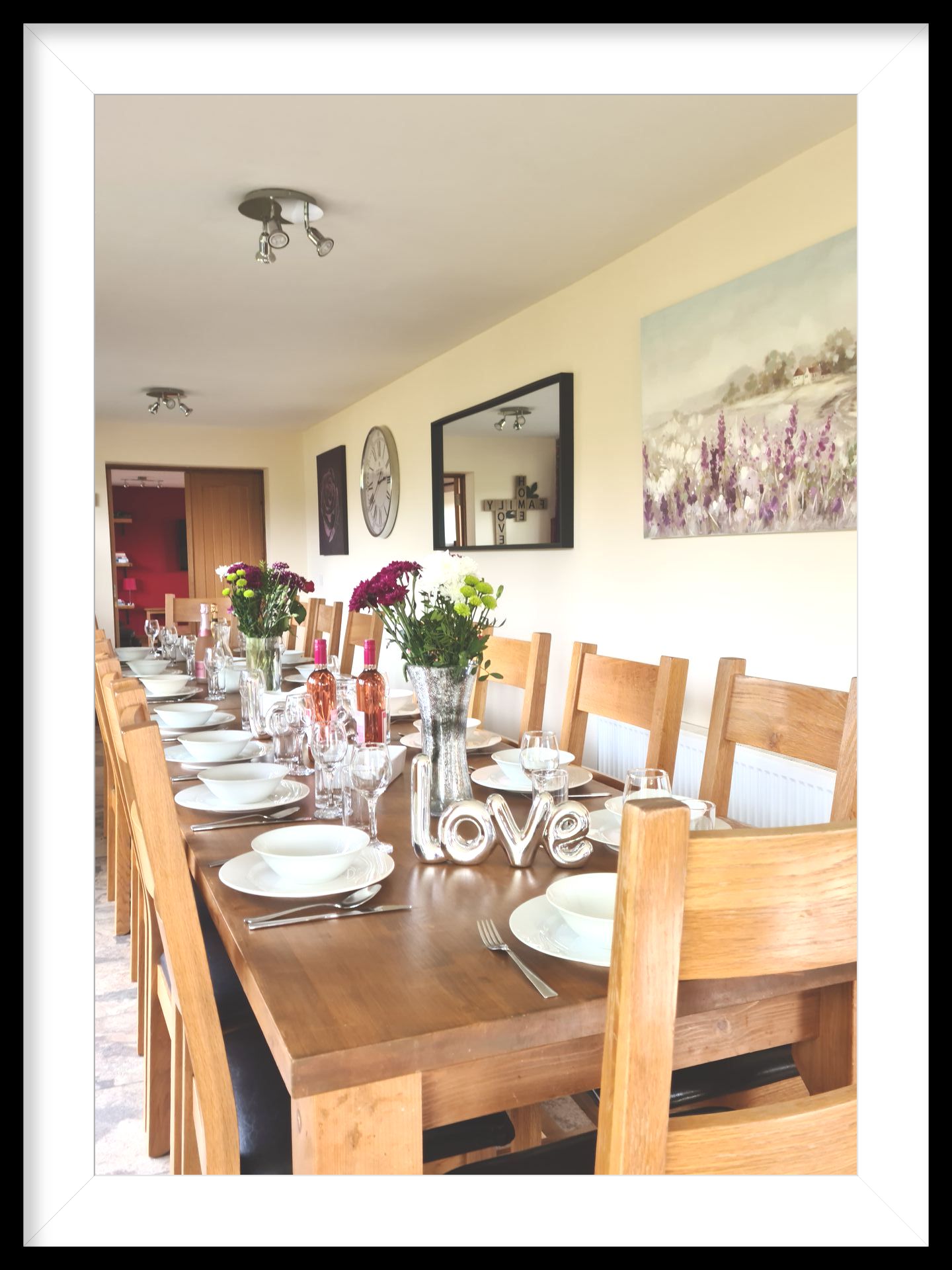 a laid dining table with flowers and wine