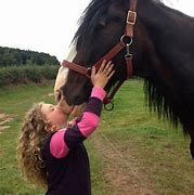 Young girl patting a horse