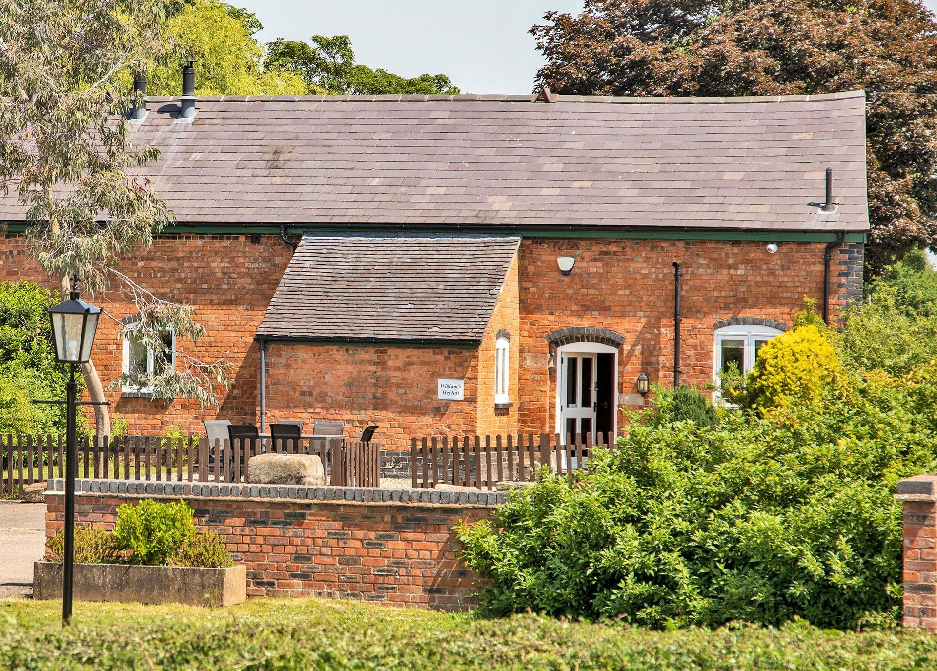 Red brick cottage with picket fence