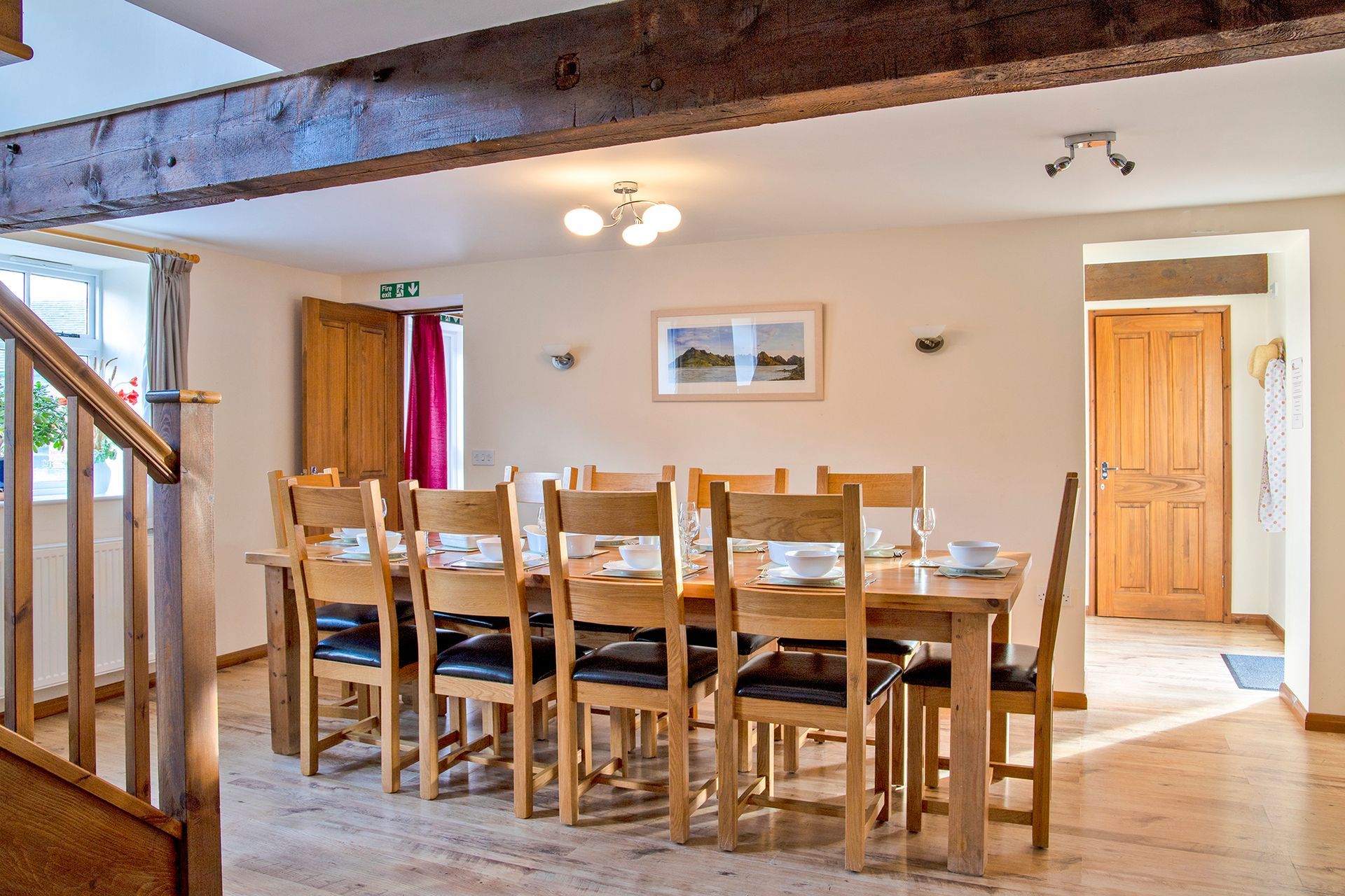 Dining table and chairs with oak beams above