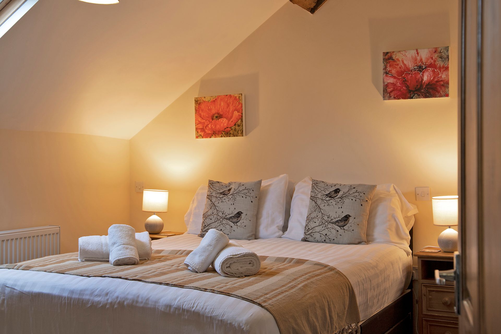 King size bed with white linen and bedside lamps