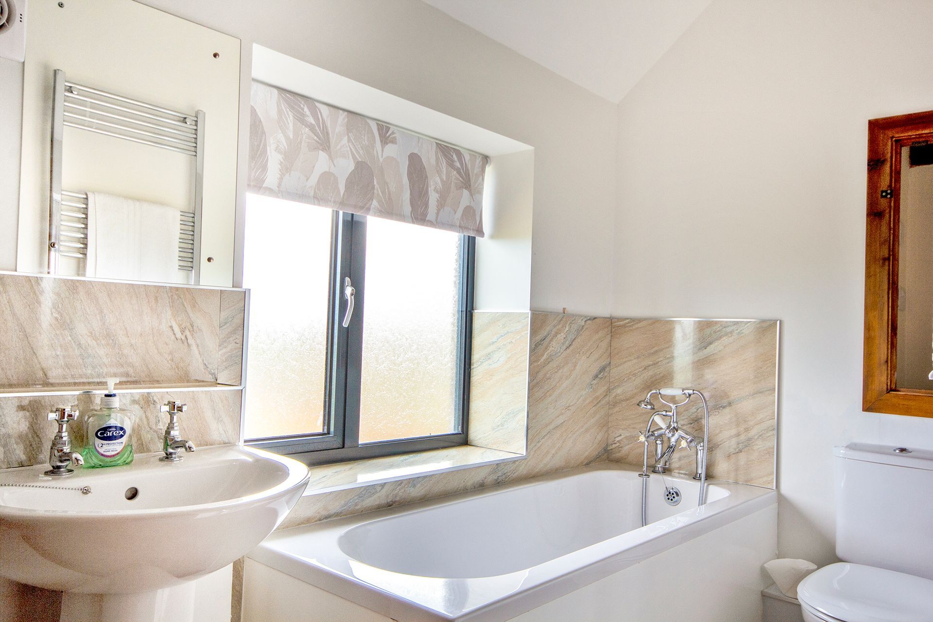 Bathroom with sink and roller blind