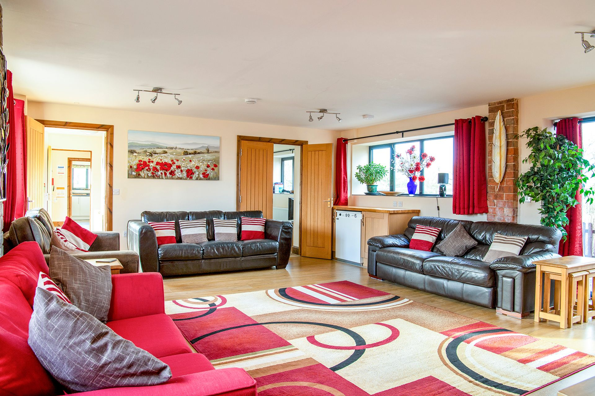 large duel aspect sitting room with leather sofas
