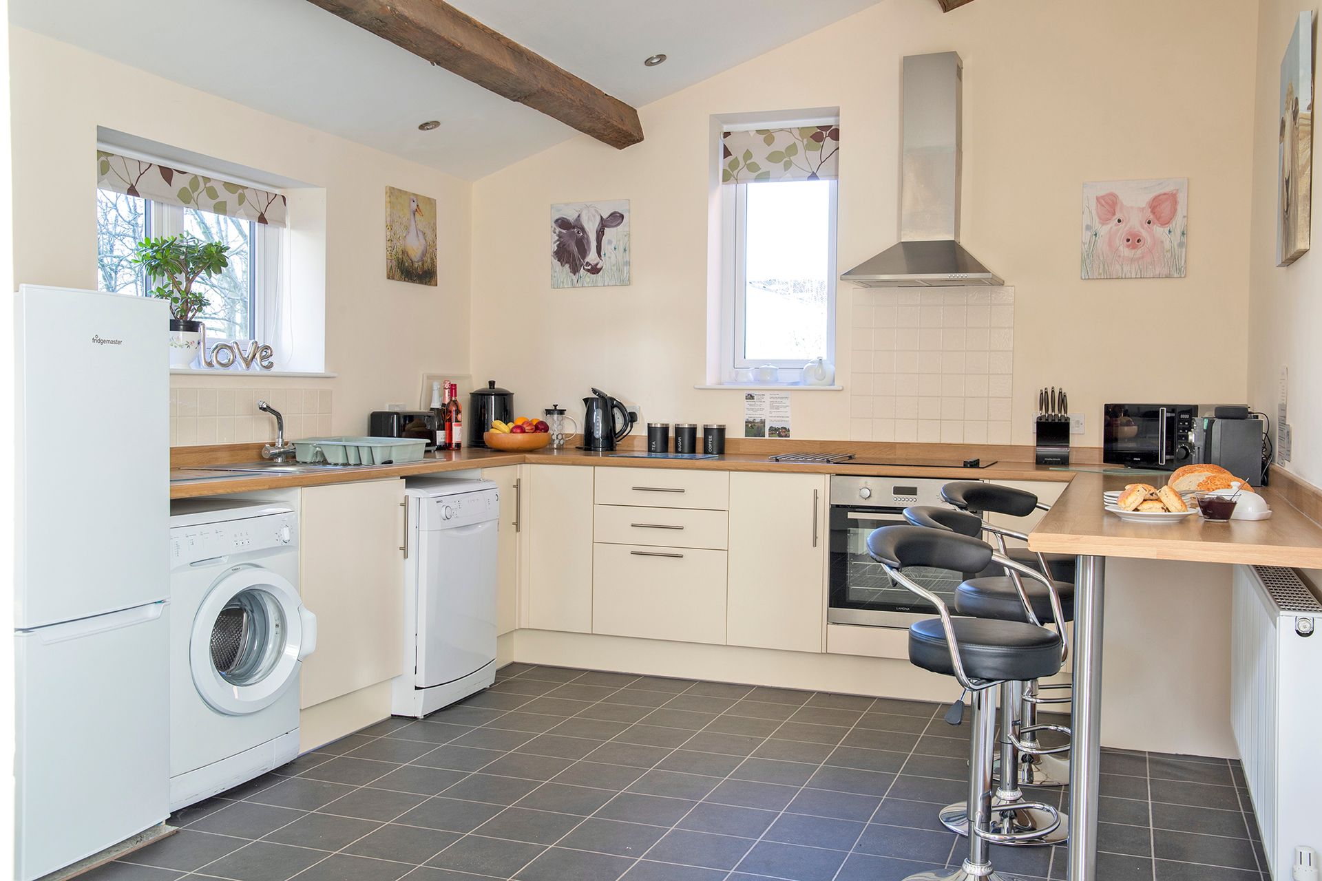 Large cream modern kitchen with fridge, washing machine and breakfast bar