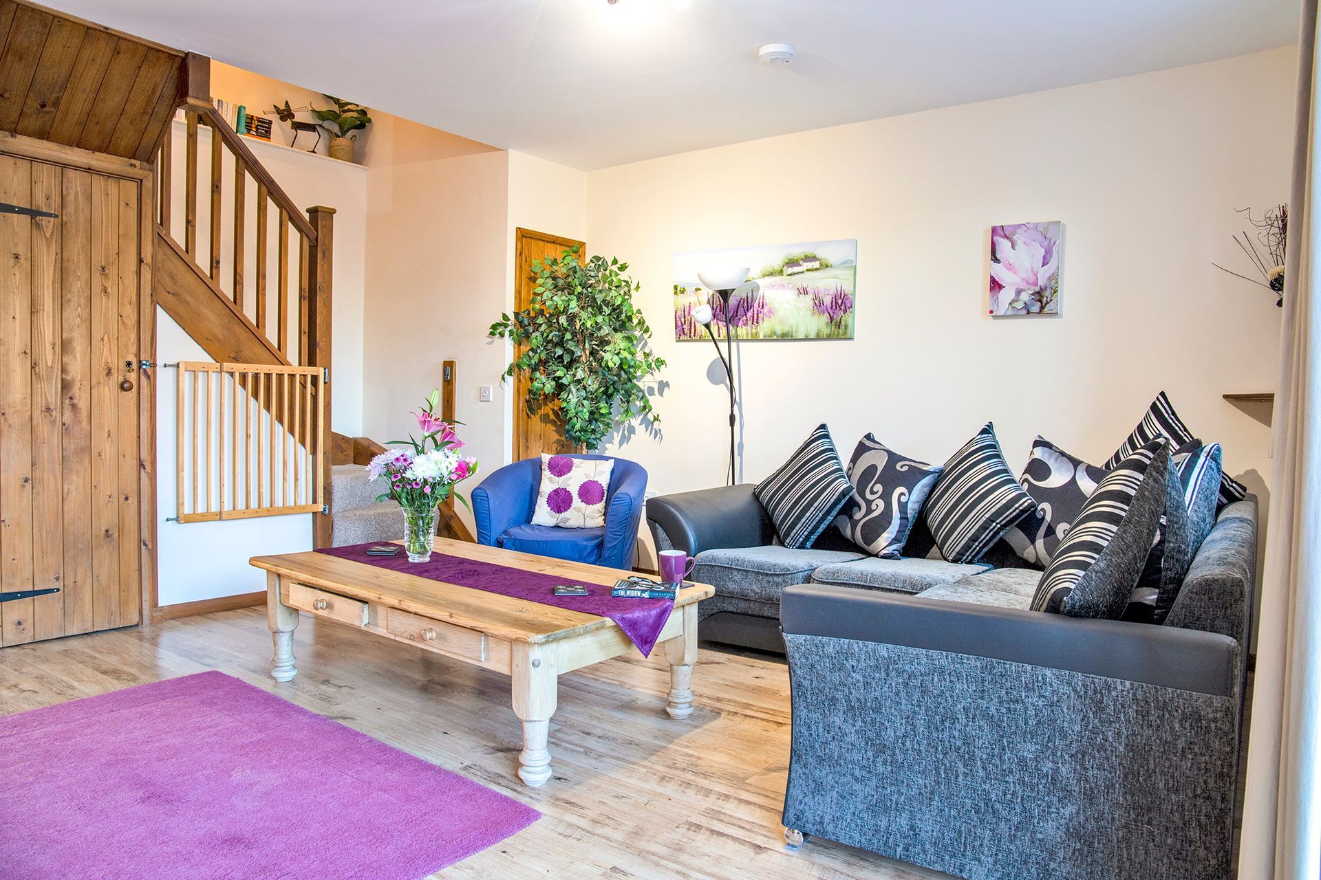 Sitting room with wooden stair case and sofa