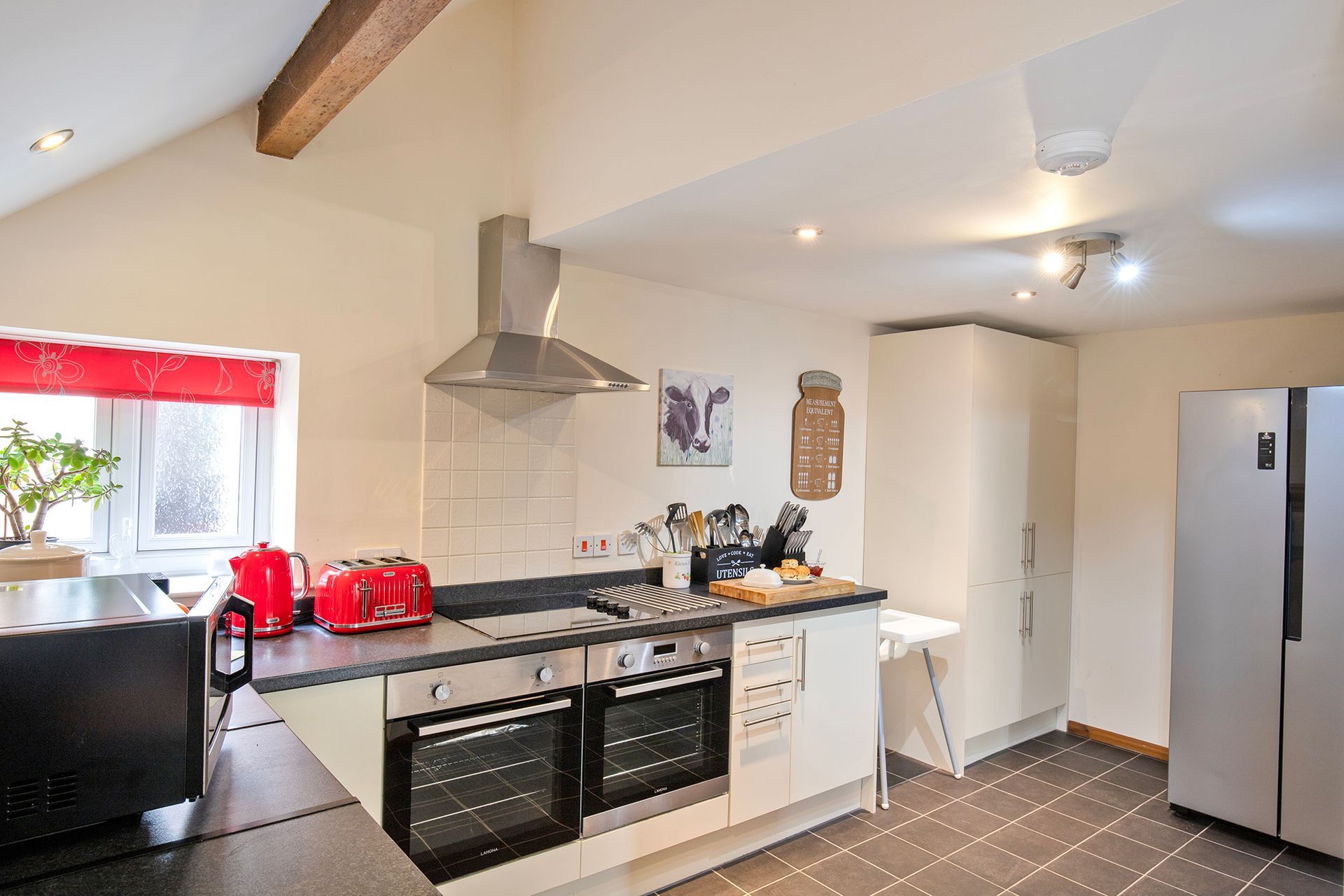 Modern kitchen with American fridge-freezer, red kettle and red toaster