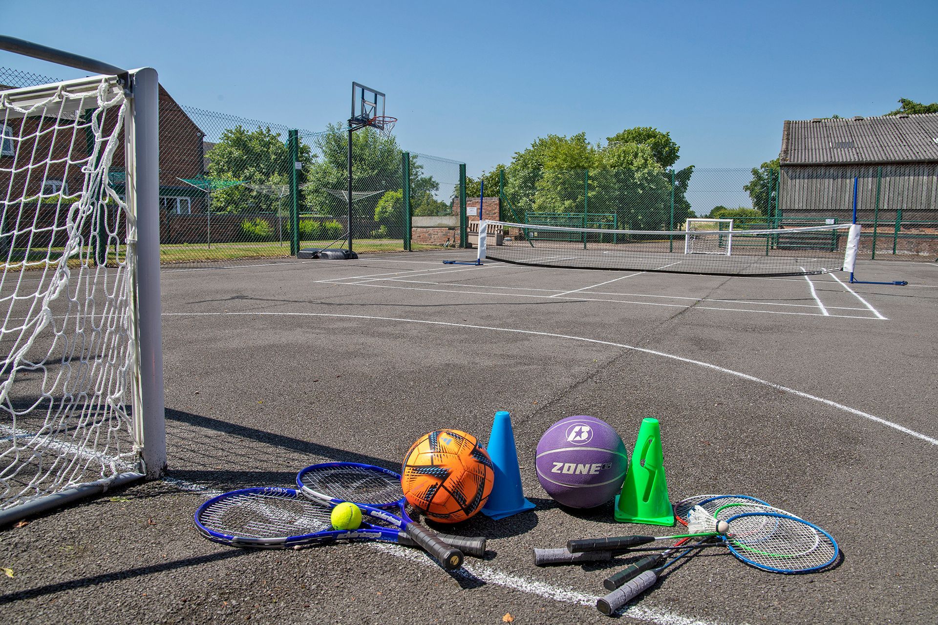 Sports court with footballs and rackets