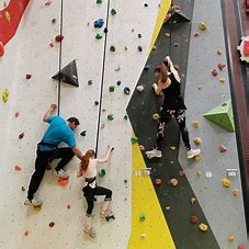 Climbing wall with climbers at climbing hut