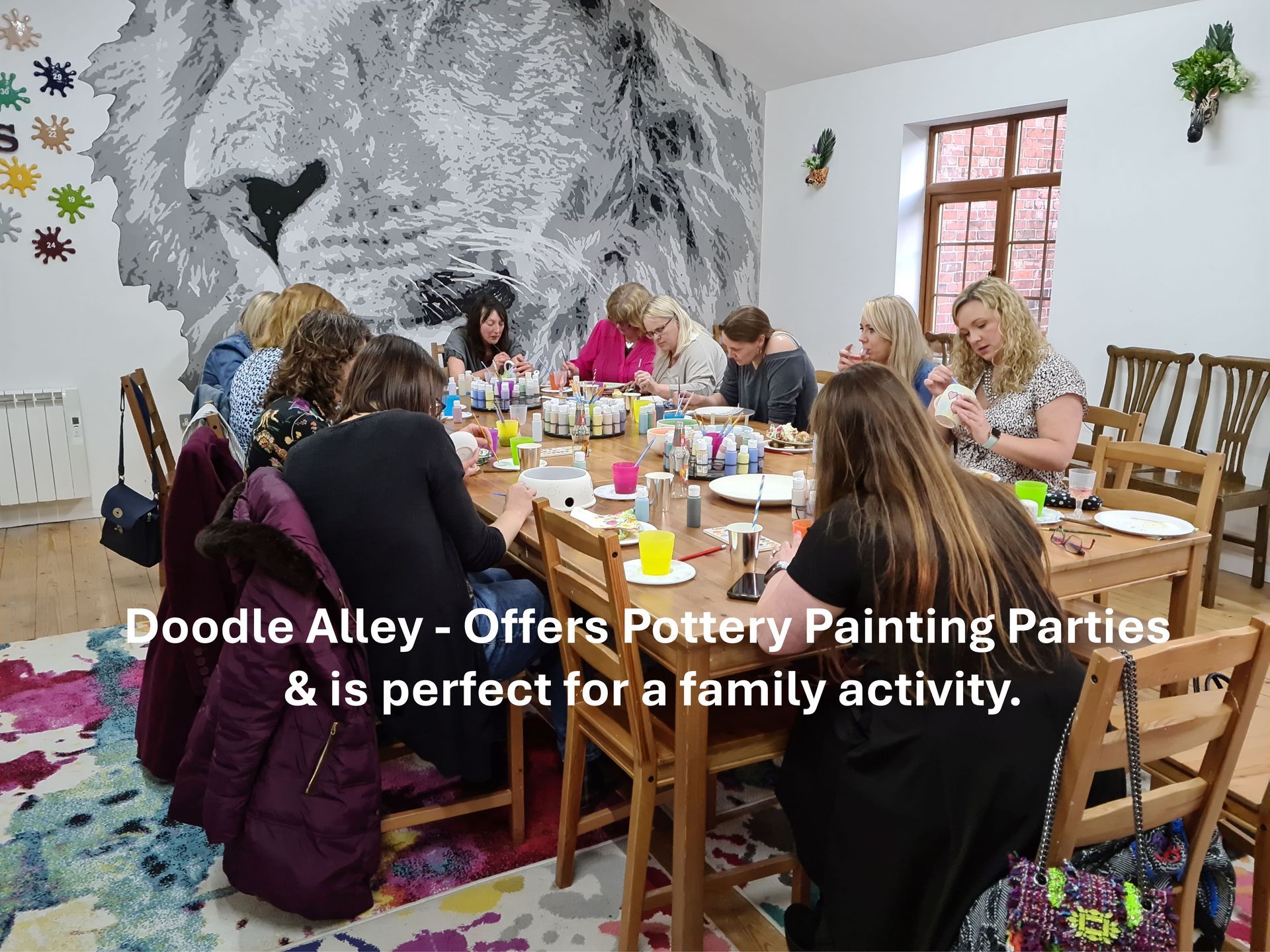a group of older women sitting at a table painting