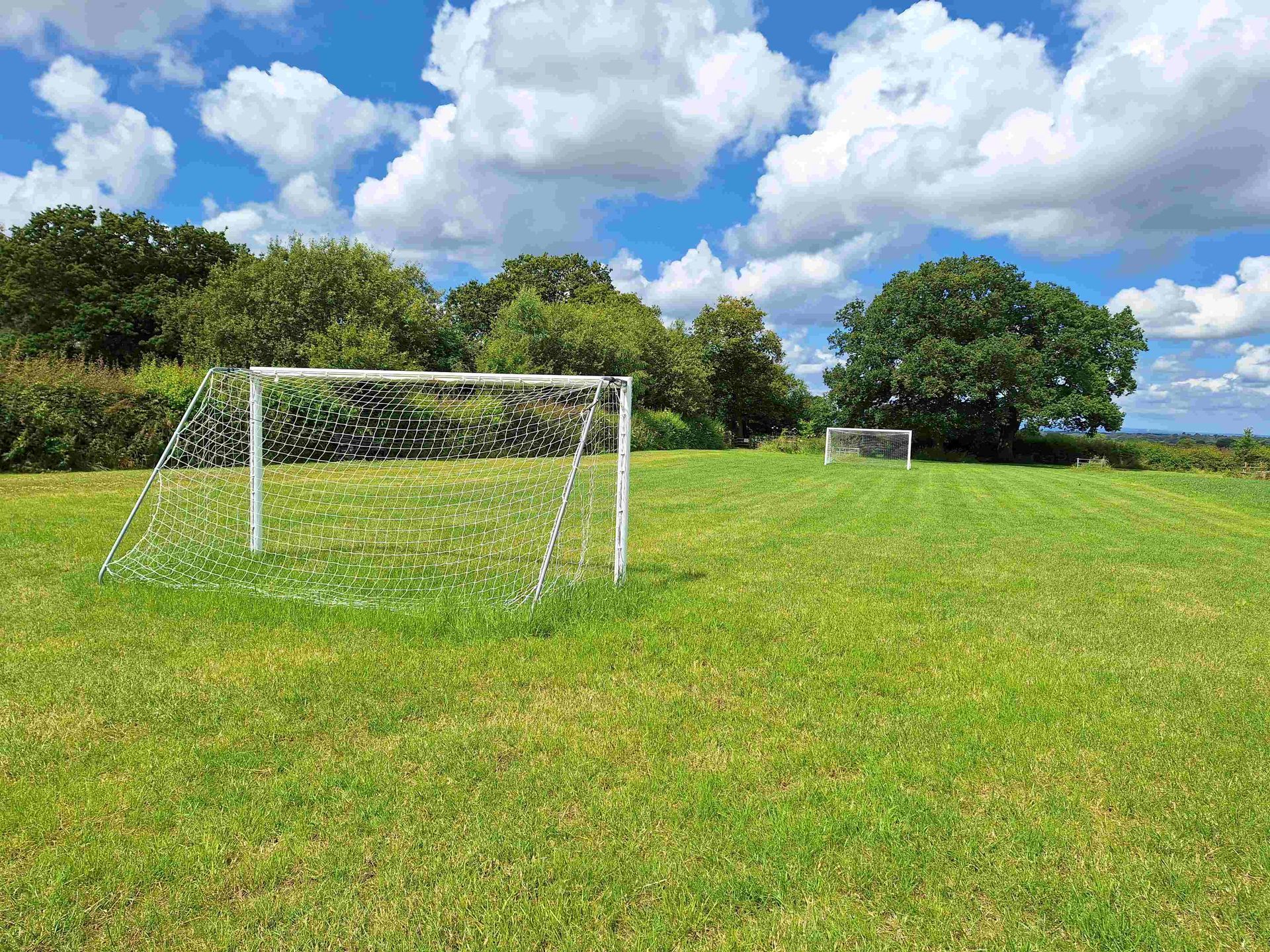 Football field with goal posts on a sunny day