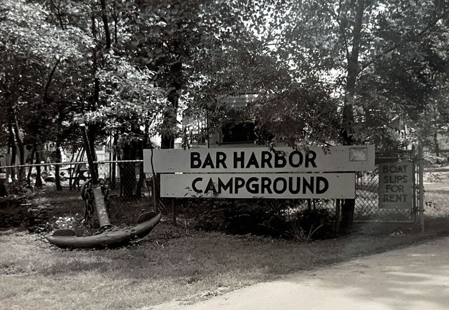 Bar Harbor Campground sign by a wooded roadside entrance