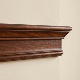 Wooden wall molding shelf detail on a beige wall