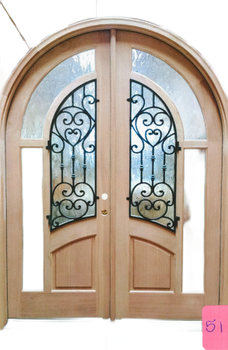 Wooden arched double door with frosted glass panels and ornate black ironwork