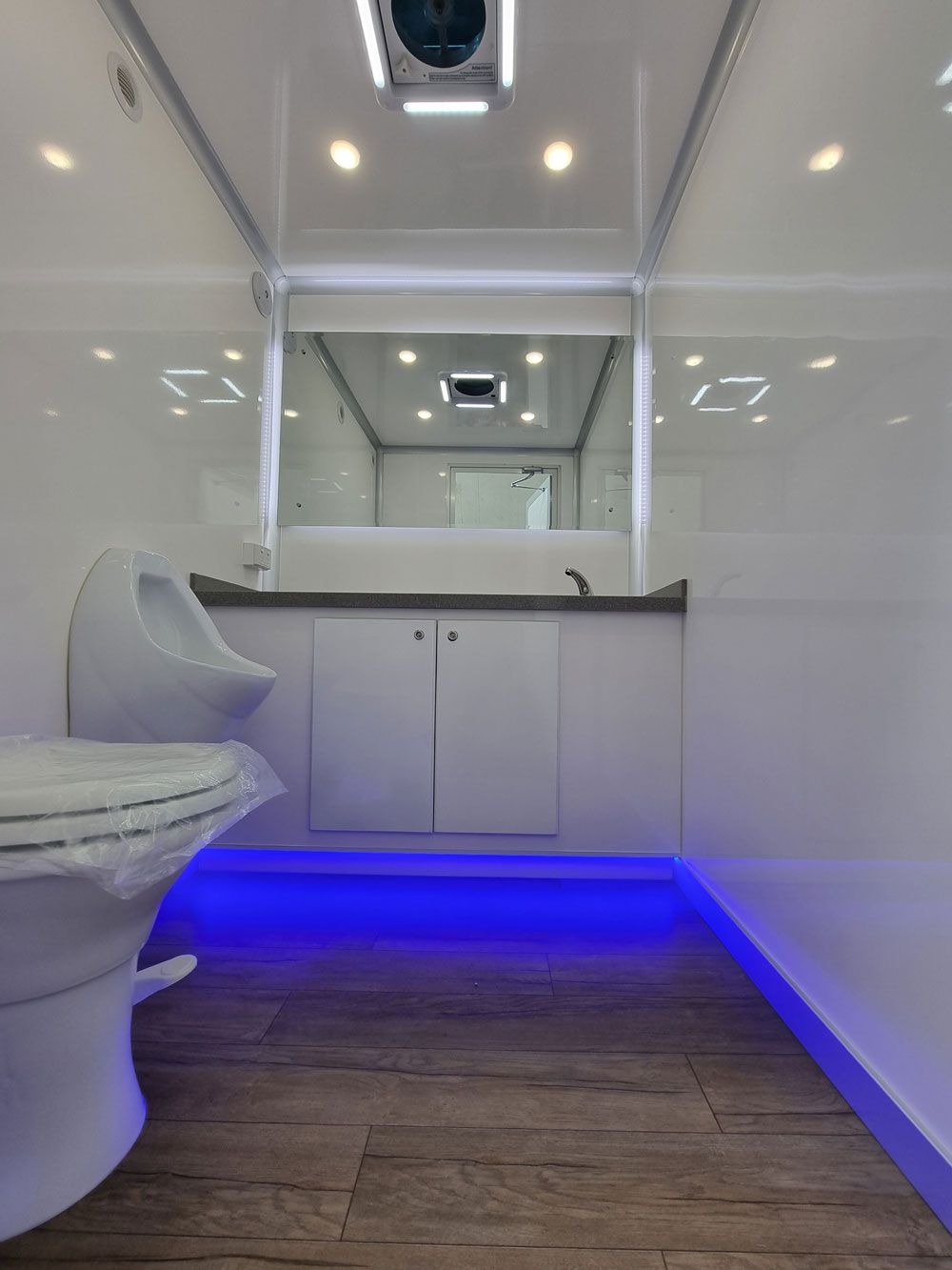 Modern Men's Toilet Featuring Ambient Blue Lighting — Ecotreat Solutions NT in Winnellie, NT