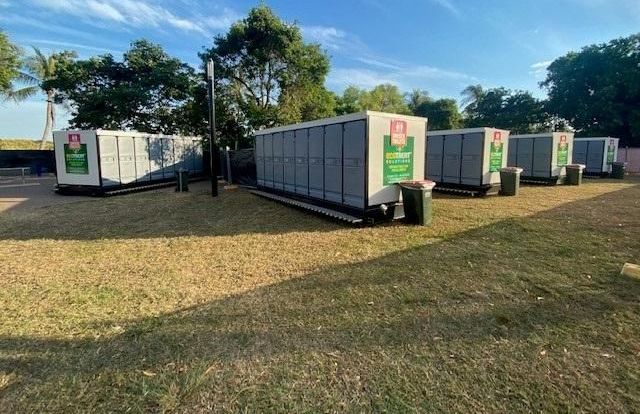 Lots of portable toilets set up on the grass — Ecotreat Solutions NT in Winnellie, NT