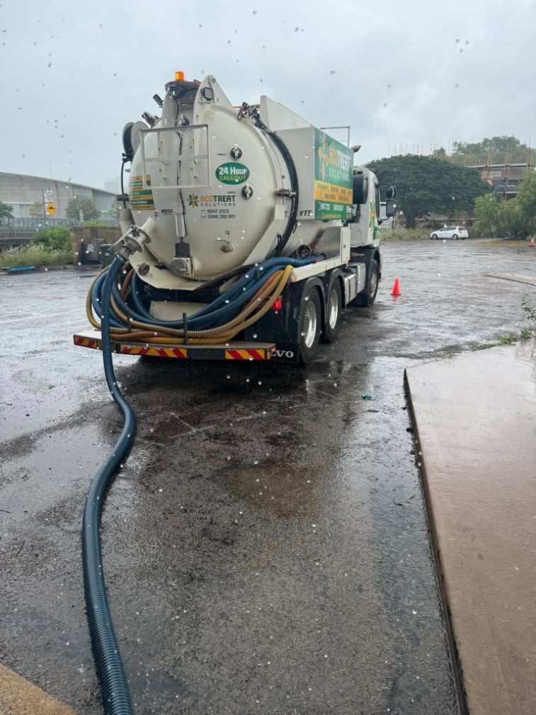 A Vacuum Truck is Parked in a Parking Lot on a Rainy Day — Ecotreat Solutions NT in Humpty Doo, NT