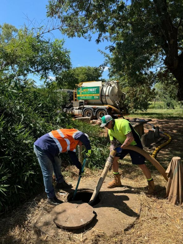Two Men Are Working on a Septic Tank With a Truck — Ecotreat Solutions NT in Winnellie, NT