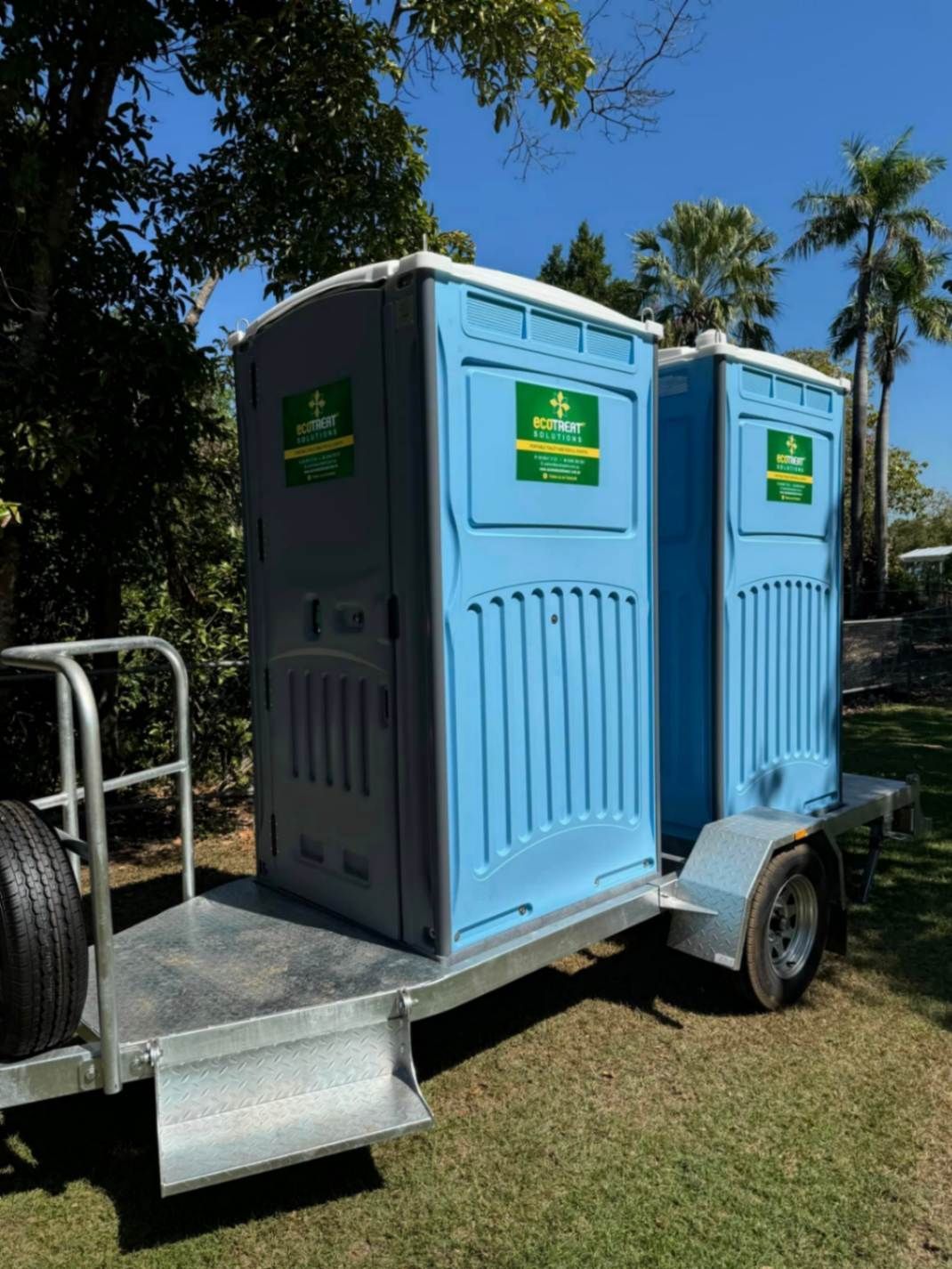 Two Blue Portable Toilets Are on a Trailer — Ecotreat Solutions NT in Winnellie, NT