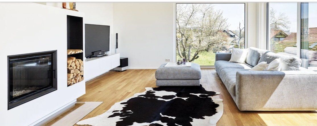 A living room with a couch , rug and fireplace.
