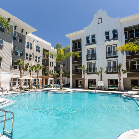 A large swimming pool in front of a building