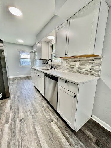 A kitchen with white cabinets and stainless steel appliances.