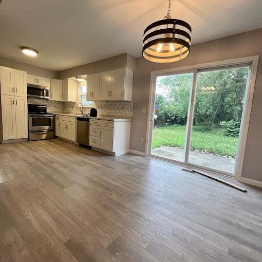 A kitchen with sliding glass doors leading to a backyard.