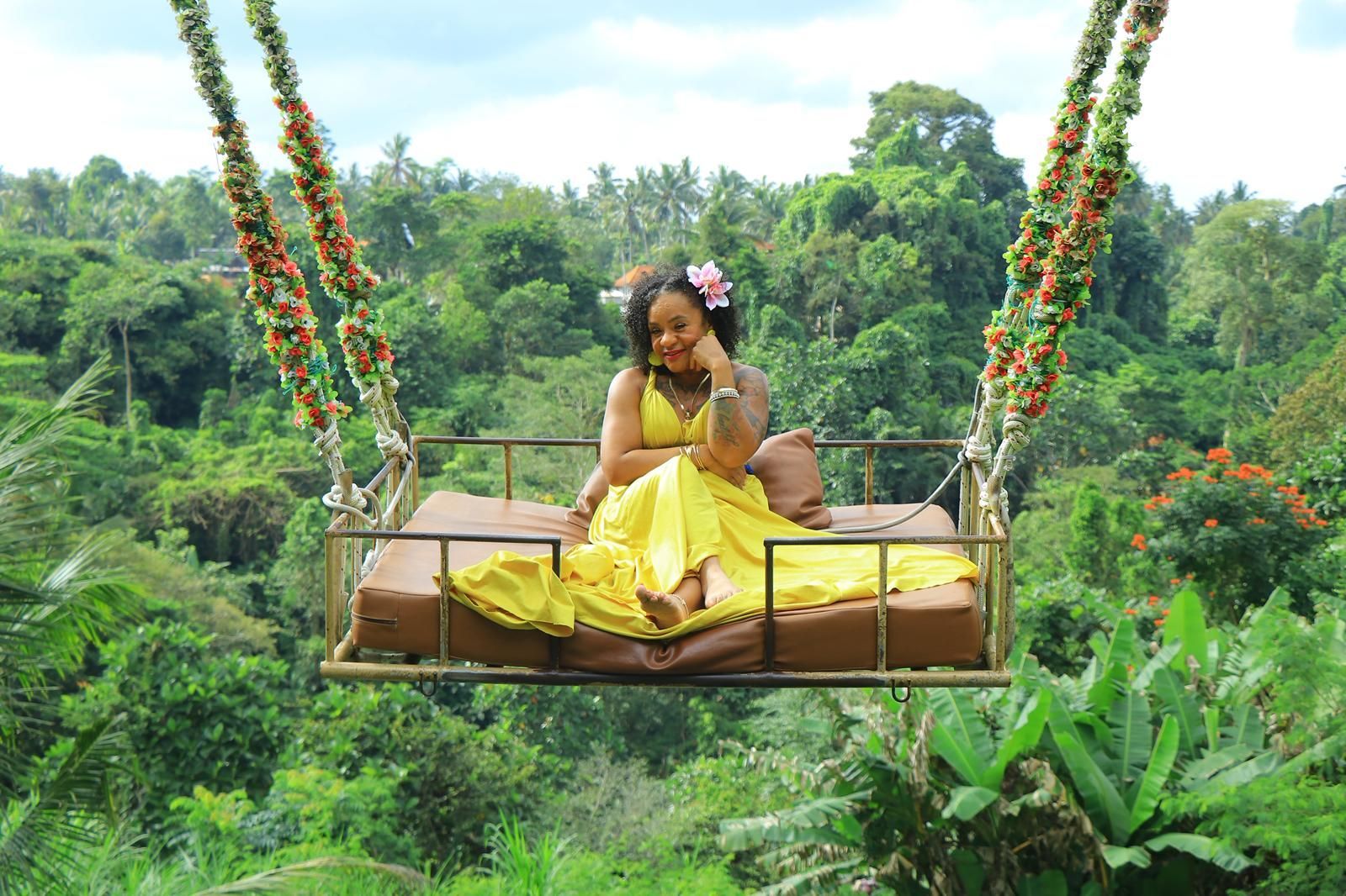 Traveler on Bali Swing soaring above Ubud rice terraces and tropical jungle
