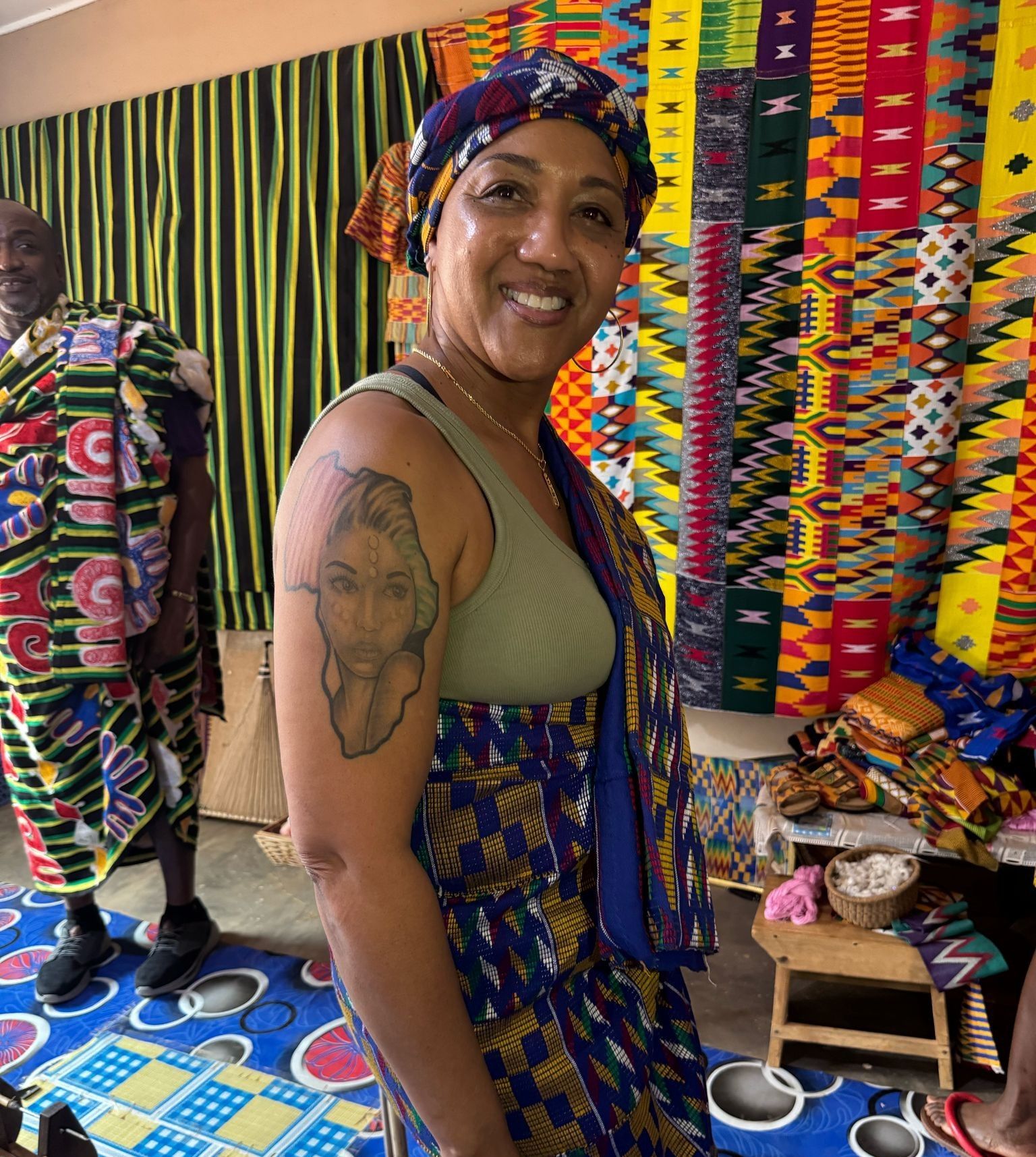 black women traveler in Kumasi wearing kente cloth
