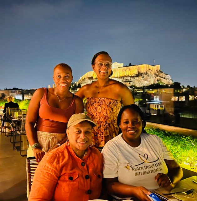 black women enjoying a rooftop dinner in Athens, Greece