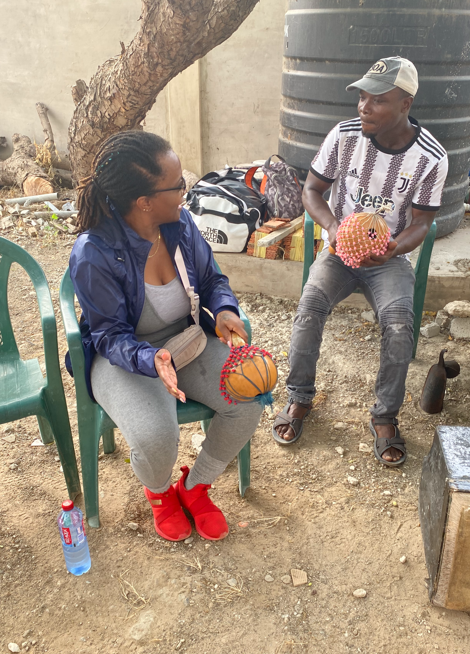 Group drumming during African naming ceremony in Ghana for Black women