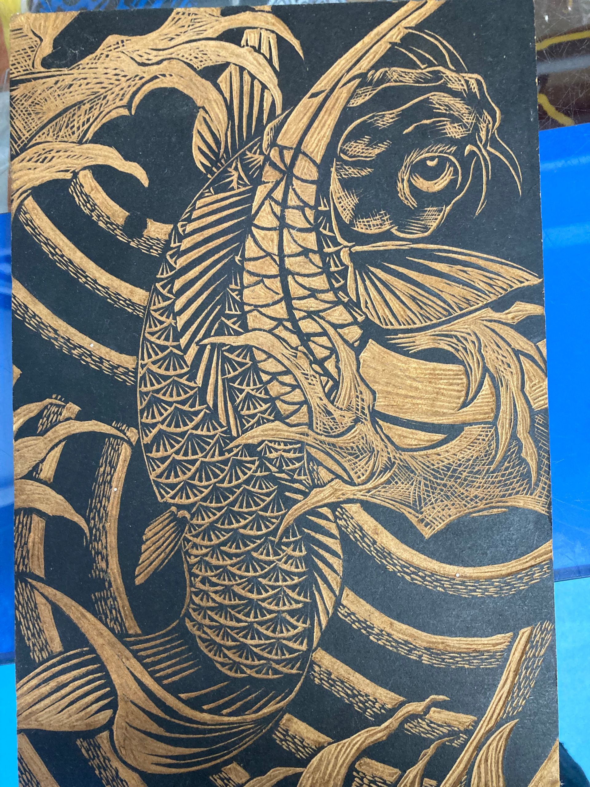 A Black and Gold Drawing of a Fish on a Blue Background — La Bomba Loca Tattoo in Cairns City, QLD