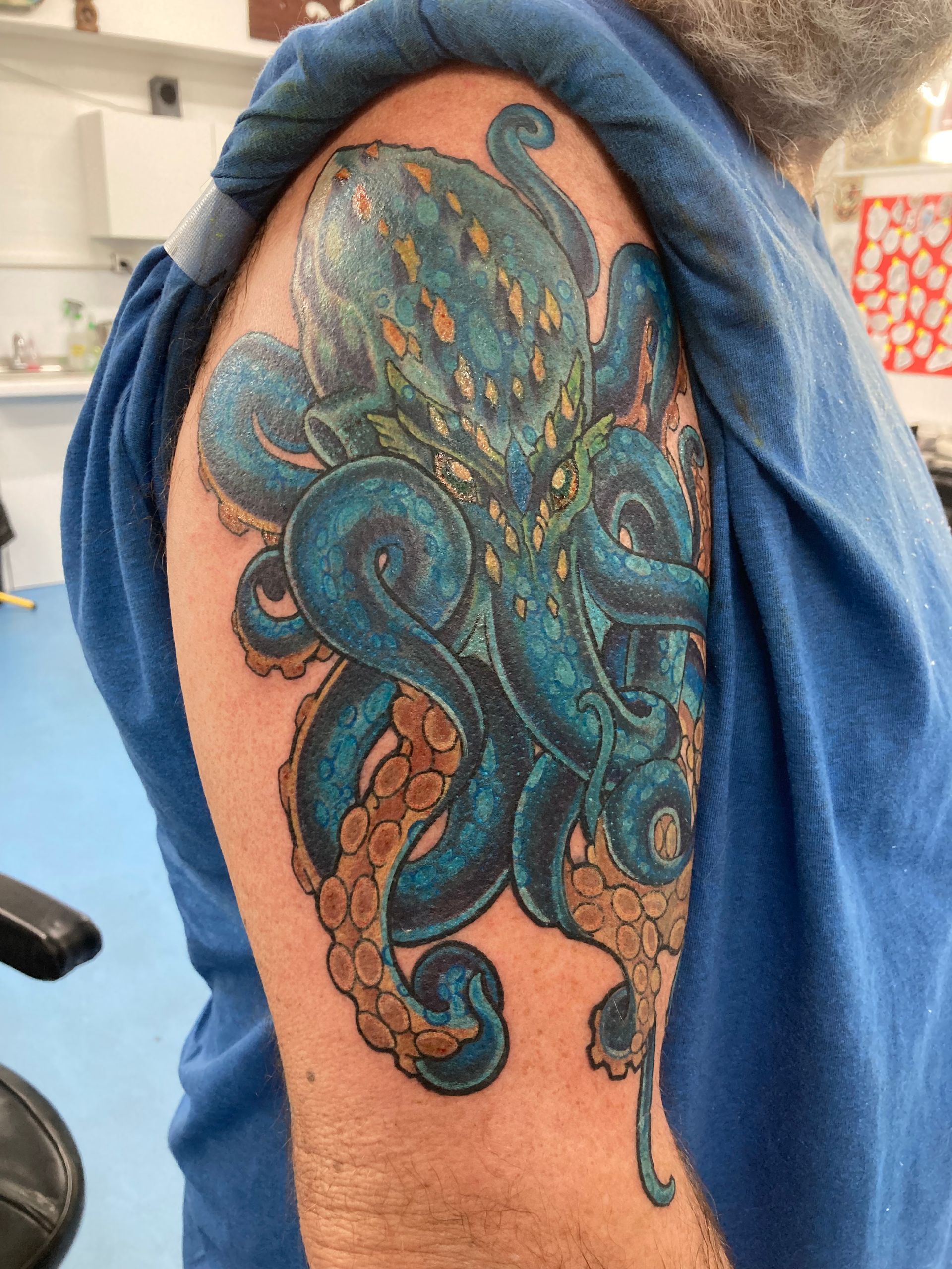 A Man Has a Blue Octopus Tattoo on His Arm — La Bomba Loca Tattoo in Cairns City, QLD