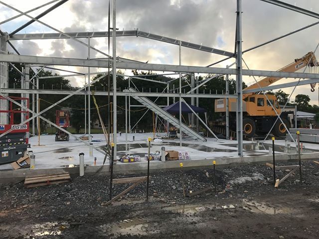 Construction Site With Exposed Steel Framing, Crane, Concrete Slab — Custom Steel Fab in Garbutt, QLD