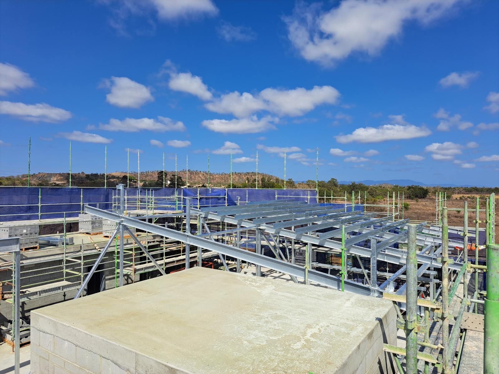 Construction Site With Metal Framework Under A Blue Sky — Custom Steel Fab in Garbutt, QLD