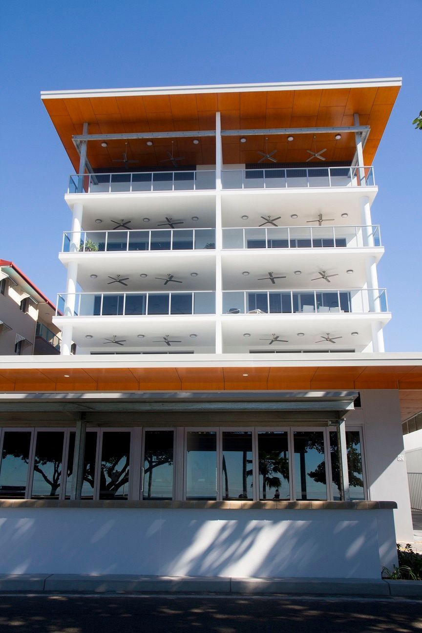 White Modern Building With Orange Accents — Custom Steel Fab in Garbutt, QLD