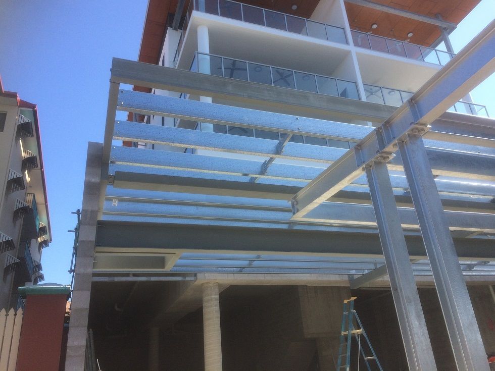 Construction of a Metal Framed Canopy Attached to a Multi-story — Norfab In Bohle, QLD