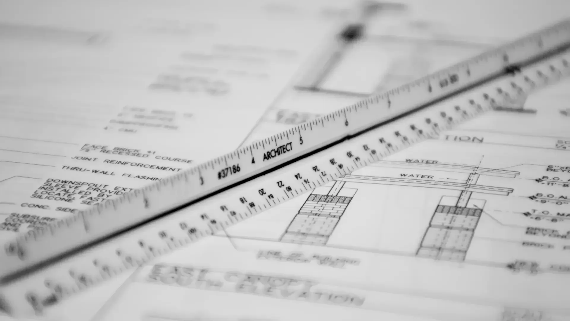 A ruler is laying on top of a black and white drawing
