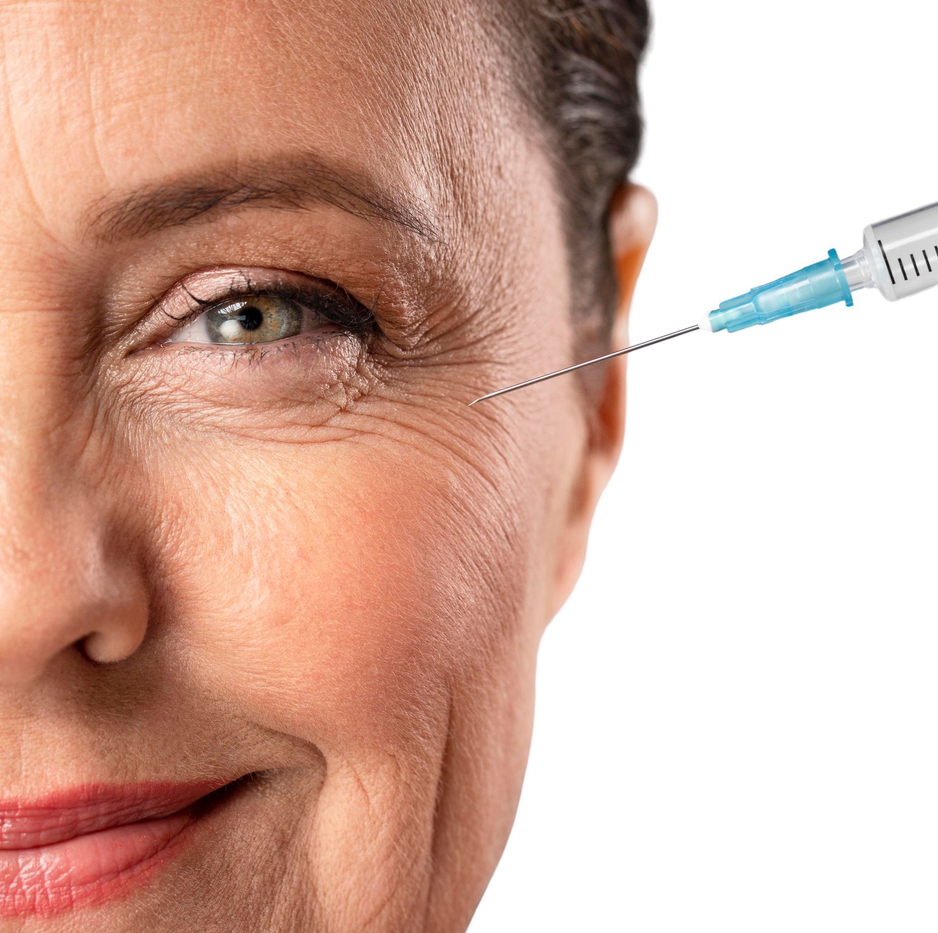 Close-up of a woman’s face with a syringe near her eye, suggesting a cosmetic injection.