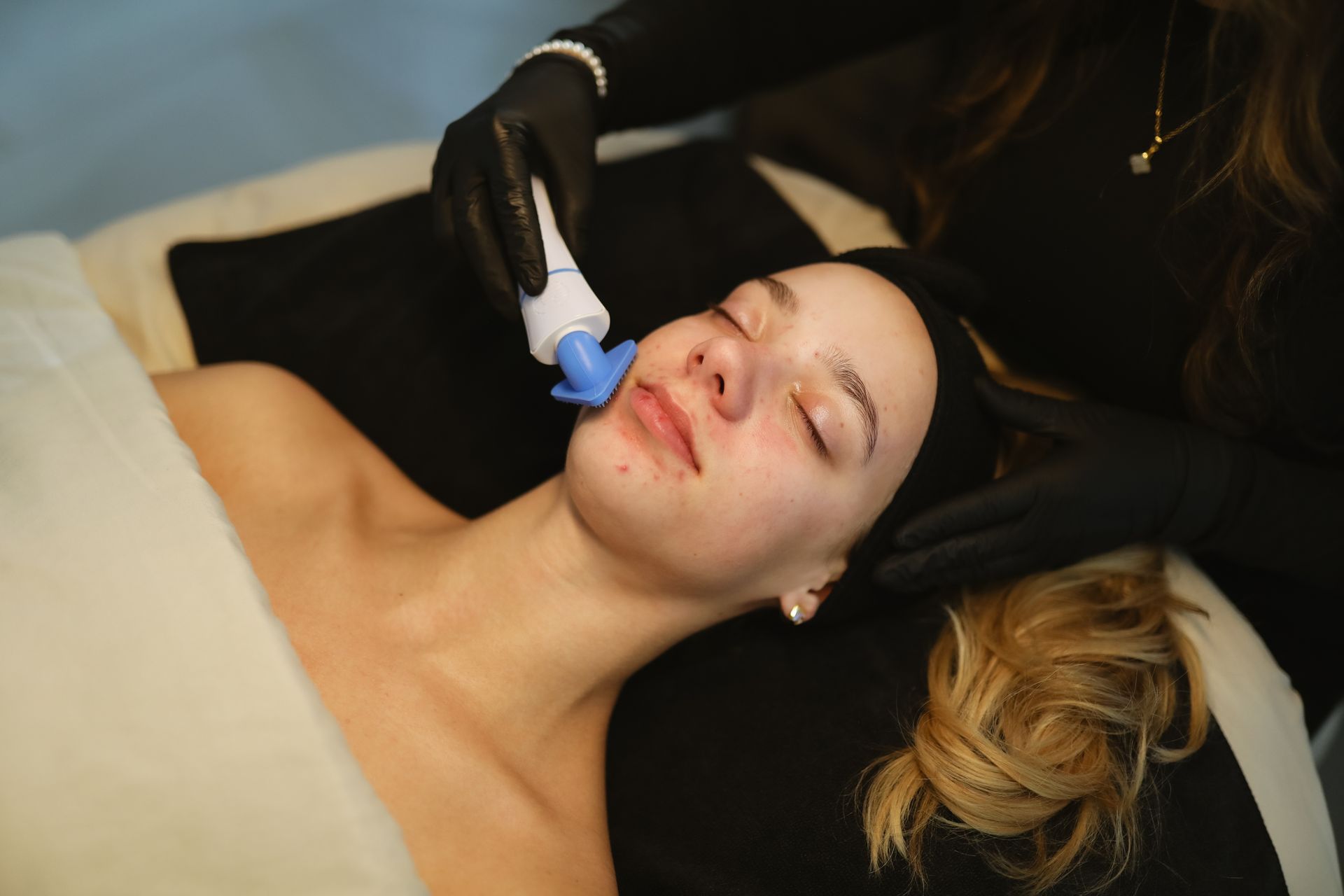 A woman is getting a facial treatment at a spa.