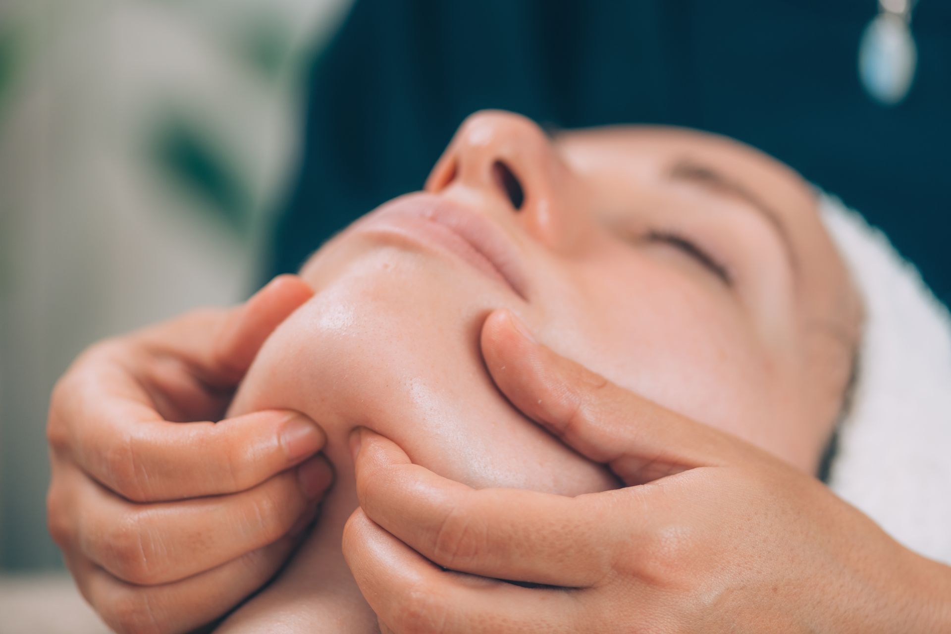 A woman is getting a facial treatment at a spa.