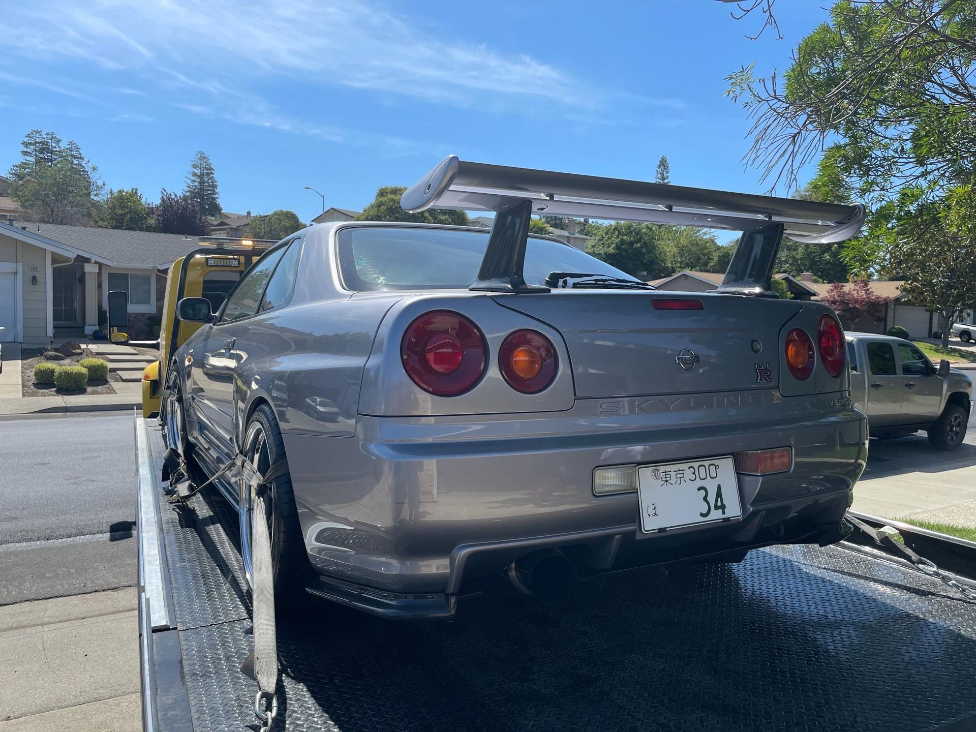 A white van is being towed by a tow truck